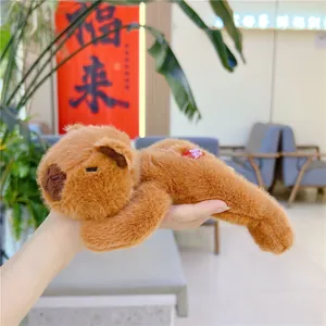 Detailed view of a soft brown capybara plush toy with a red heart on the back