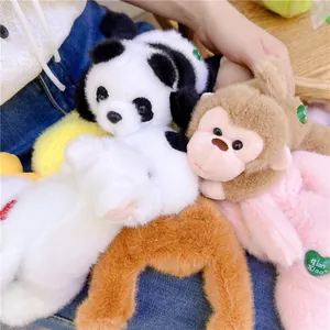 Close-up of soft plush panda and monkey toys with heart tags on denim background