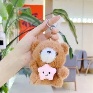 Plush brown bear holding a pink star keychain for bags and school backpacks