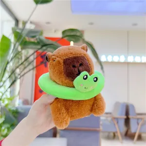 Close-up of brown Capybara plush keychain with a cute green frog swim ring decoration