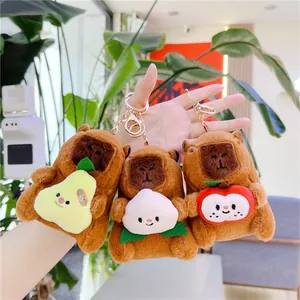 Cute capybara plush keychain holding fruit set in soft brown fabric with metal ring