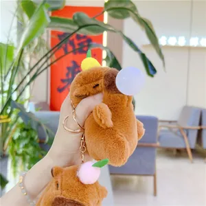 Close-up of cute Capybara plush keychain with a bubble blowing design and pink pompom