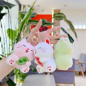 Plush lucky cat charms in pink, white, and green with metallic keyrings for bags