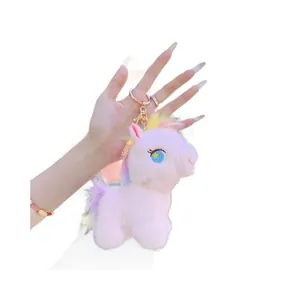 Pink plush unicorn keychain with rainbow mane and a rose gold lobster clasp accessory