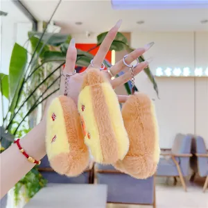 Three plush bread and hot dog keychains in yellow and brown with silver metal rings