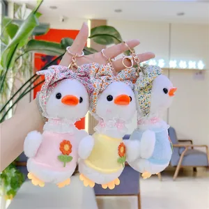 Three plush duck keychains in pink yellow and blue with floral bandanas and lace collars