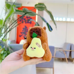 Close-up of a cute plush capybara keychain holding a pear with unique bandage detail