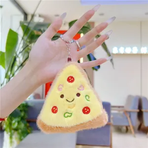 Detailed view of a plush pizza slice keychain with embroidered face and metal clip
