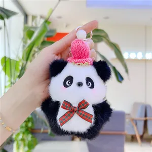 Detail of panda plush keychain with pink knitted hat and red-green plaid bow tie accessory
