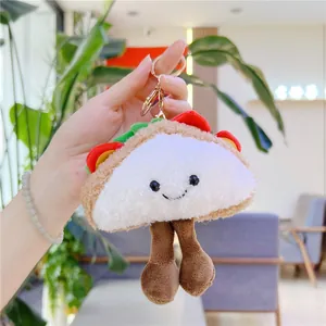 Creative taco plush keychain with cute expression and golden clip held by a hand