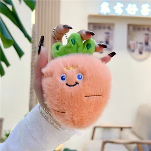 Plush peach fruit keychain with soft faux fur and cute facial embroidery