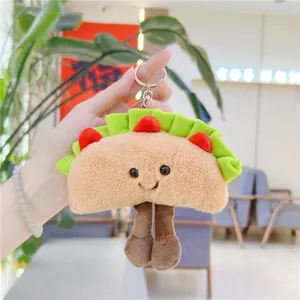 Macro detail of cute plush taco keychain with smiling face and metallic gold ring