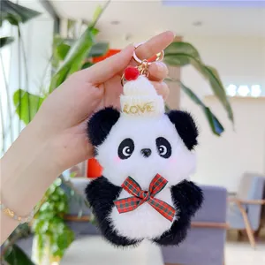 Close-up of cute panda plush keychain with LOVE hat and a plaid bow on a gold ring