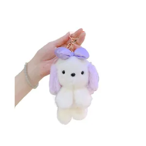Portachiavi cucciolo di peluche con orecchie viola e fiocco in morbida ecopelliccia