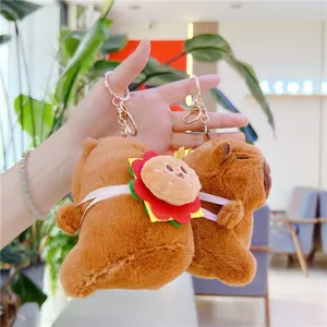 Close-up of plush Capybara keychains with hamburger details and golden metal ring