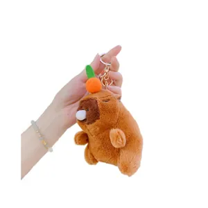 Brown Capybara plush keychain with orange and bubble detail on white background