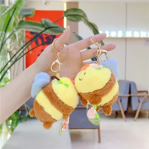 Cute plush honey bee keychain with colorful flower details and blue wings for gifting