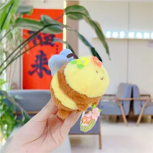 Close-up of cute plush bee keychain with soft fabric texture and striped detail
