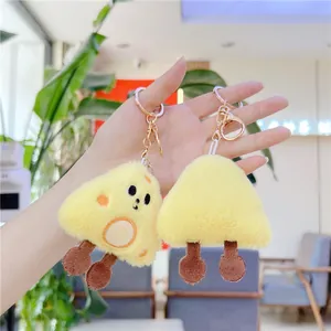 Cute plush cheese wedge keychains with creative embroidery and soft texture in hand
