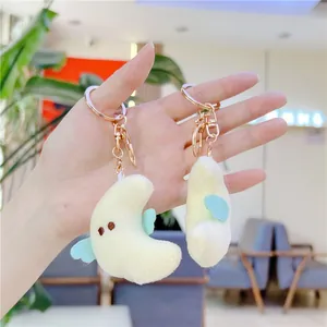 Cute moon plush keychain set with soft yellow fabric, wings and gold metal clasps
