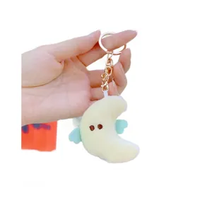 Cute yellow plush moon keychain with blue wings and a shiny golden lobster clasp