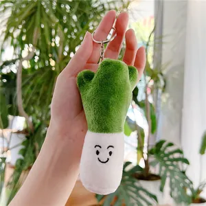 Cute green onion plush keychain with a smiling face and metallic silver ring holder
