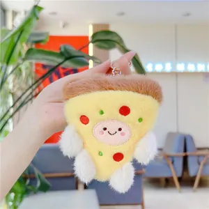 Detail of creative plush pizza keychain with cute smiling face and soft yellow fabric