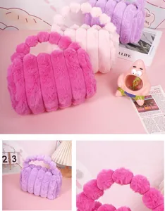 Close-up of plush faux rabbit fur makeup bags in pink and purple with striped texture