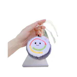 Cute sushi plush keychain with soft white and black fur and golden metal lobster clasp