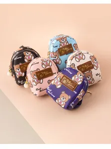 Detail of mini bear backpacks in five colors with pearl zippers and gold hardware