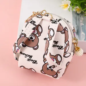 Detail of mini bear coin purse with teddy print, golden zipper and pearl pendant decoration