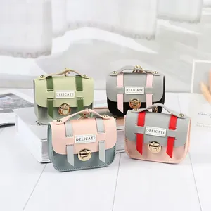 Detail of mini PU leather coin purses with metallic locks and keychains in various colors