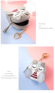 Detailed close-up of owl-shaped mini coin purses with zipper and gold keychain