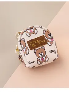 Detail of bear print coin purse with gold zipper, key ring and pearl charm accent