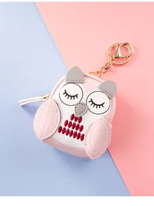 Detailed close-up of pink owl coin purse keychain with golden metal lobster clasp
