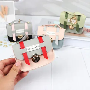 Detail of mini laser pouches in multiple colors with metal buckle and delicate logo
