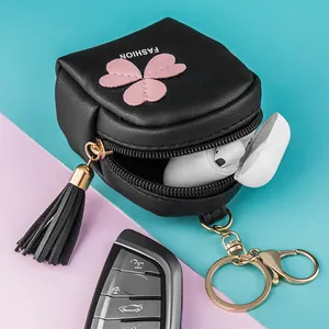 Mini leather coin purse in black with pink clover patch and long tassel keychain
