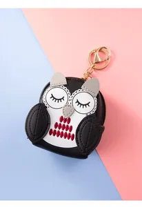 Detail view of owl coin purse keychain with premium black leather and red embroidery