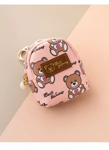 Detail of pink bear coin purse featuring a British flag tee and pearl ball charm