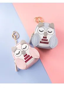 Macro detail of PU leather owl coin purses with embroidery and golden keychain hardware