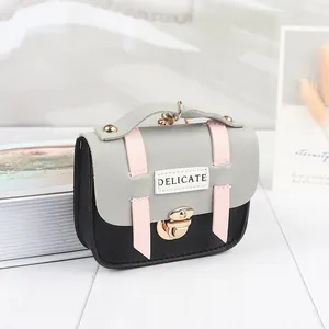 Detailed view of the mini purse featuring a tri-color PU leather design and metal buckle