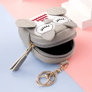 Cute grey cat-shaped PU leather coin purse keychain with embroidery on creative background