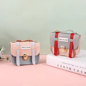Mini crossbody bags in pink and grey faux leather with elegant golden metal buckles