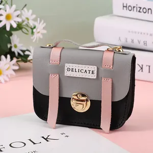 Close-up of tricolor leather mini bag with metal lock and Delicate label detail