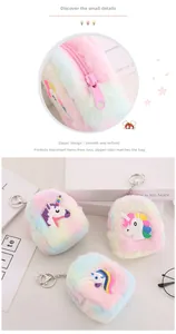 Close-up of rainbow plush unicorn coin purse with pink zipper and metal keyring