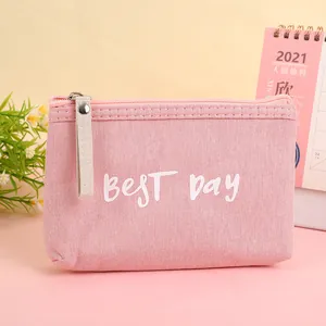 Pink canvas pouch with 'BEST Day' text featuring zipper closure and minimalist style