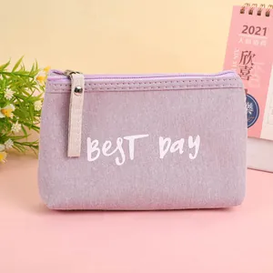 Detail of lavender canvas pouch with Best Day print and cream zipper pull close-up