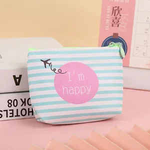 Detail of light blue striped coin purse featuring a happy slogan and fluorescent green zipper