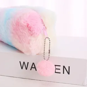Close-up of rainbow plush pencil case featuring soft faux fur and a fuzzy ball pendant