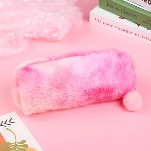 Detail of pink gradient plush pencil case with fluffy texture and cute pom-pom pendant